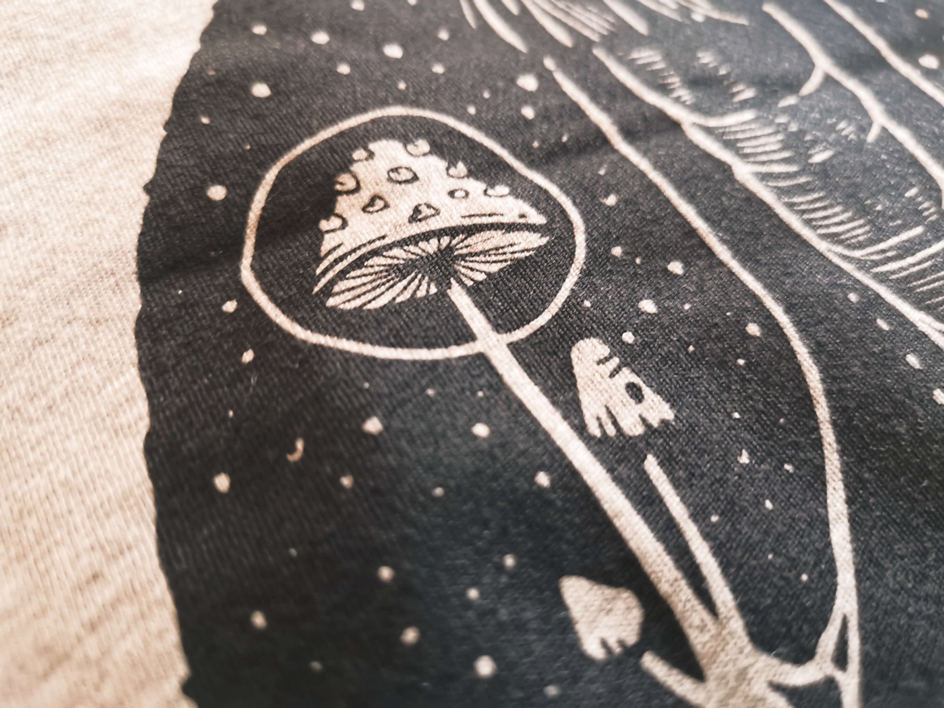 Close up to the mushroom detail on our goblincore goth t-shirt.
