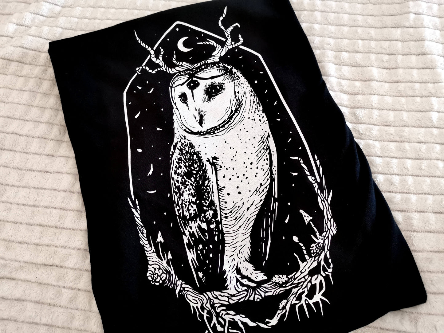 Close up of our three-eyed owl Stolas, the Goetic Prince of Hell on a super soft 100% ringspun combed cotton unisex t-shirt.