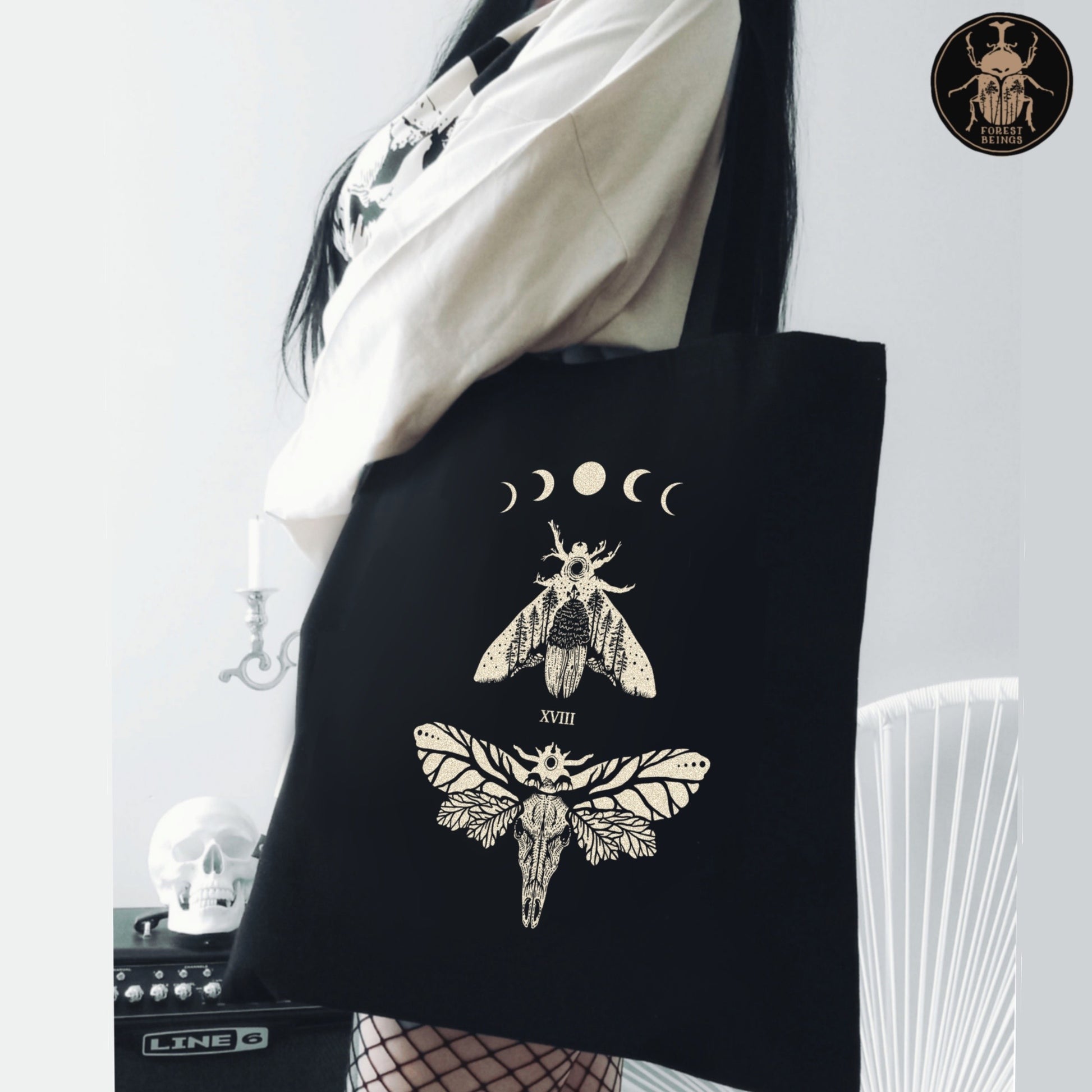 Death head moths gothic tote bag worn by a goth goblincore girl.