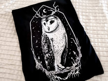 Load image into Gallery viewer, Close up of our three-eyed owl Stolas, the Goetic Prince of Hell on a super soft 100% ringspun combed cotton unisex t-shirt.
