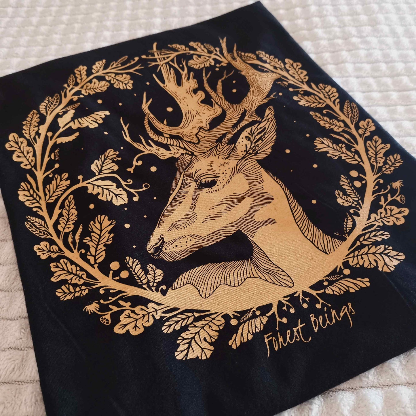 Close up to our golden autumn deer design on a soft goth aesthetic black t-shirt