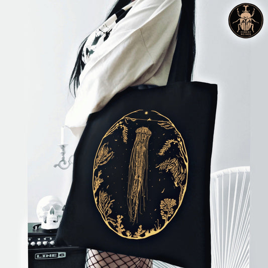 A golden jellyfish and a fisherman print on a black aesthetic gothic tote bag.