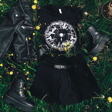 Load image into Gallery viewer, Magical mushroom forest graphic gothic t-shirt laying in a flower meadow. 
