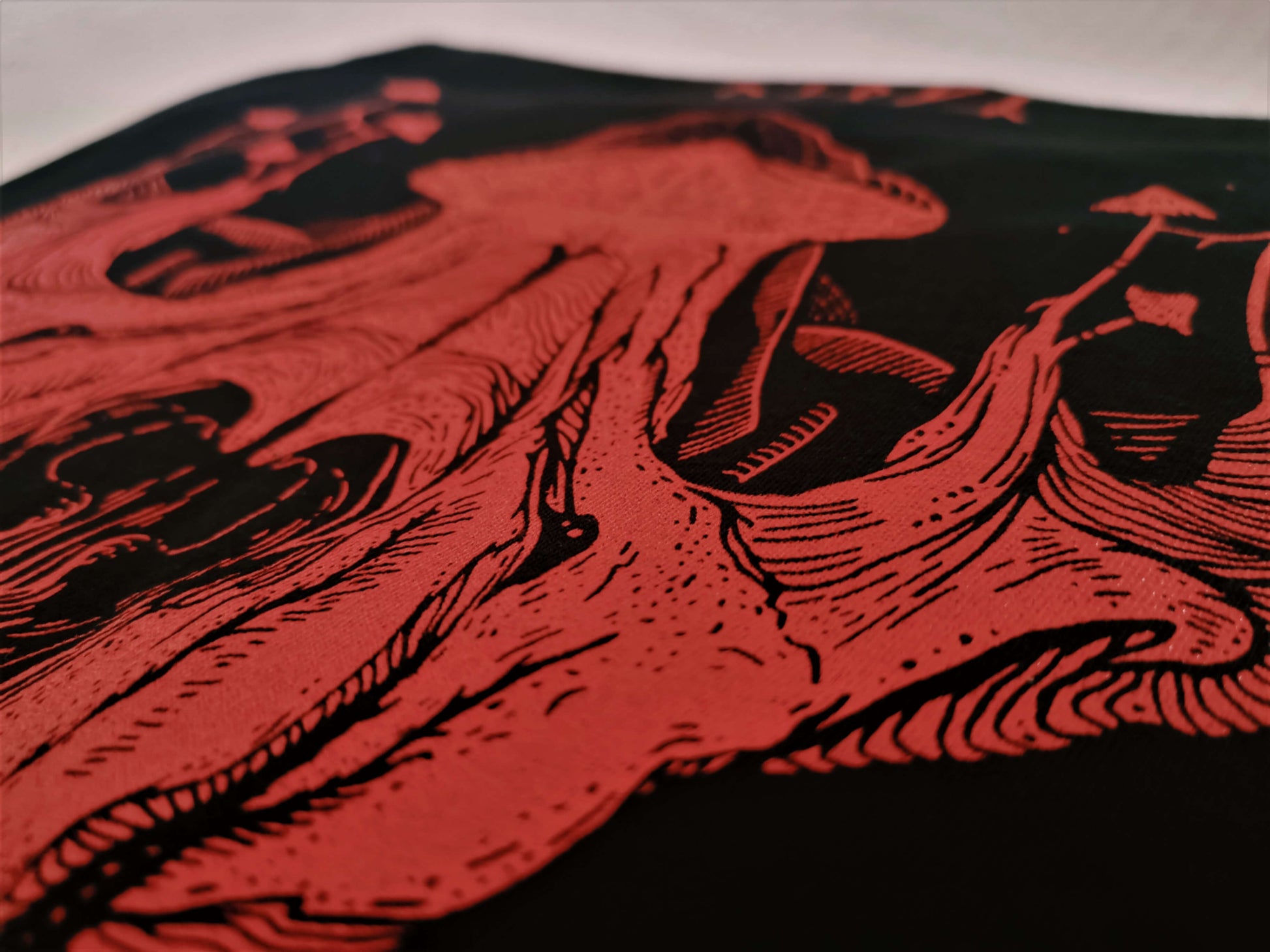 Close up to a screen-printed wolf skull gothic design t-shirt.
