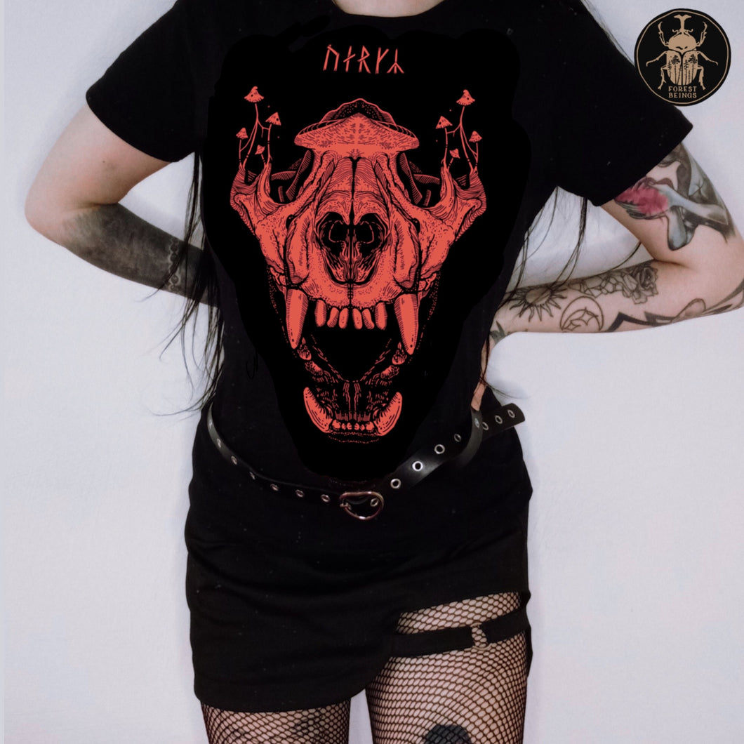  Cute witchy goth girl with long black hair and tattoos on her arms and legs, wearing an aesthetic goth graphic t-shirt. with a red big wolf skull on it.